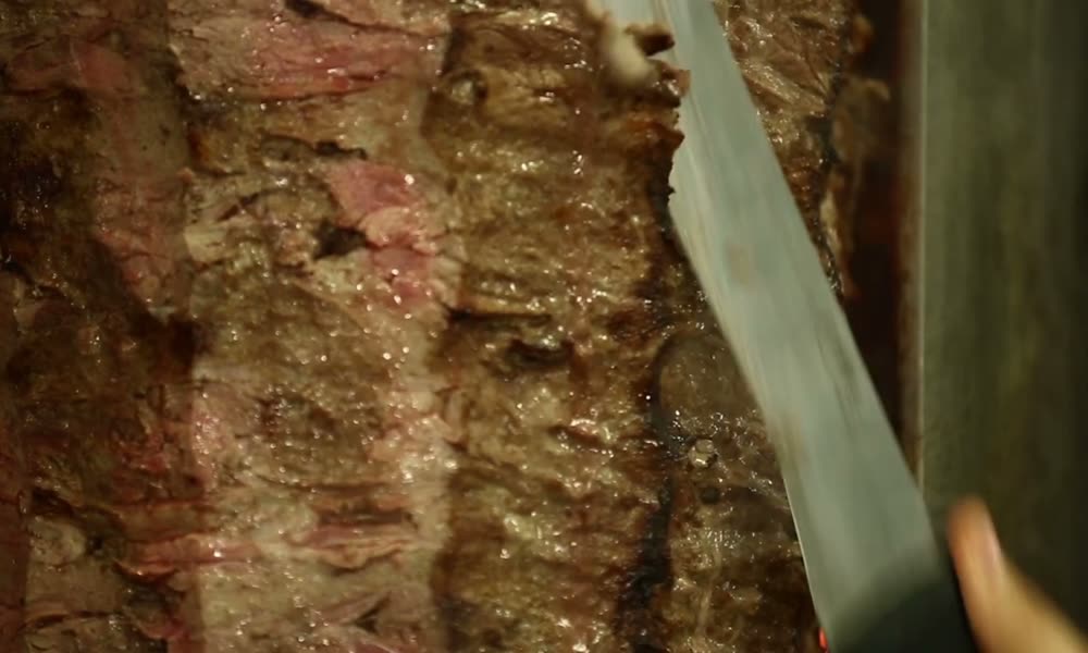 Döner ustası ocak başında yaprak döner keserken